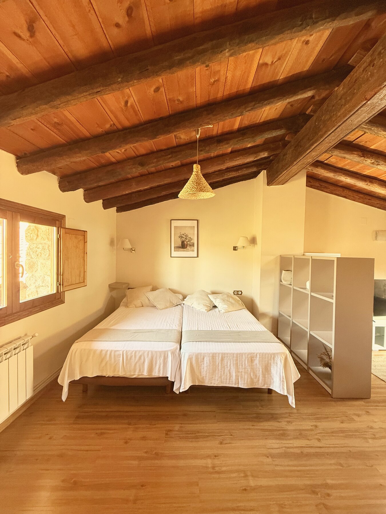 Dormitorio del ático loft bajo vigas de madera